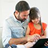 Father and daughter using tablet