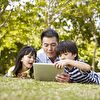 Father With Daughter and Son Using Tablet
