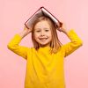 Girl With Book on Head in Yellow